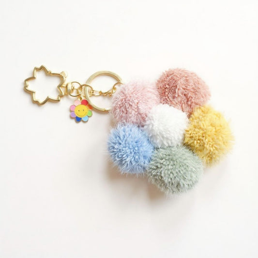 Anna-Kaci Multicolor Pom Pom Keychain with Gold Flower Charm and Smiley Accent