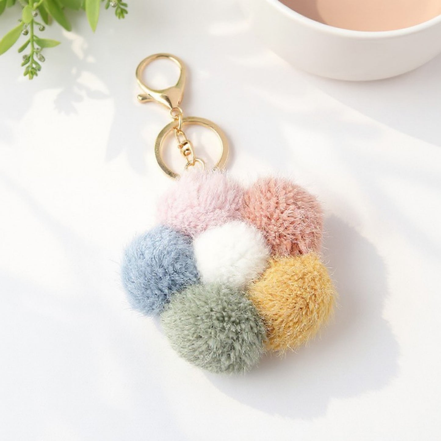 Anna-Kaci Multicolor Pom Pom Keychain with Gold Flower Charm and Smiley Accent