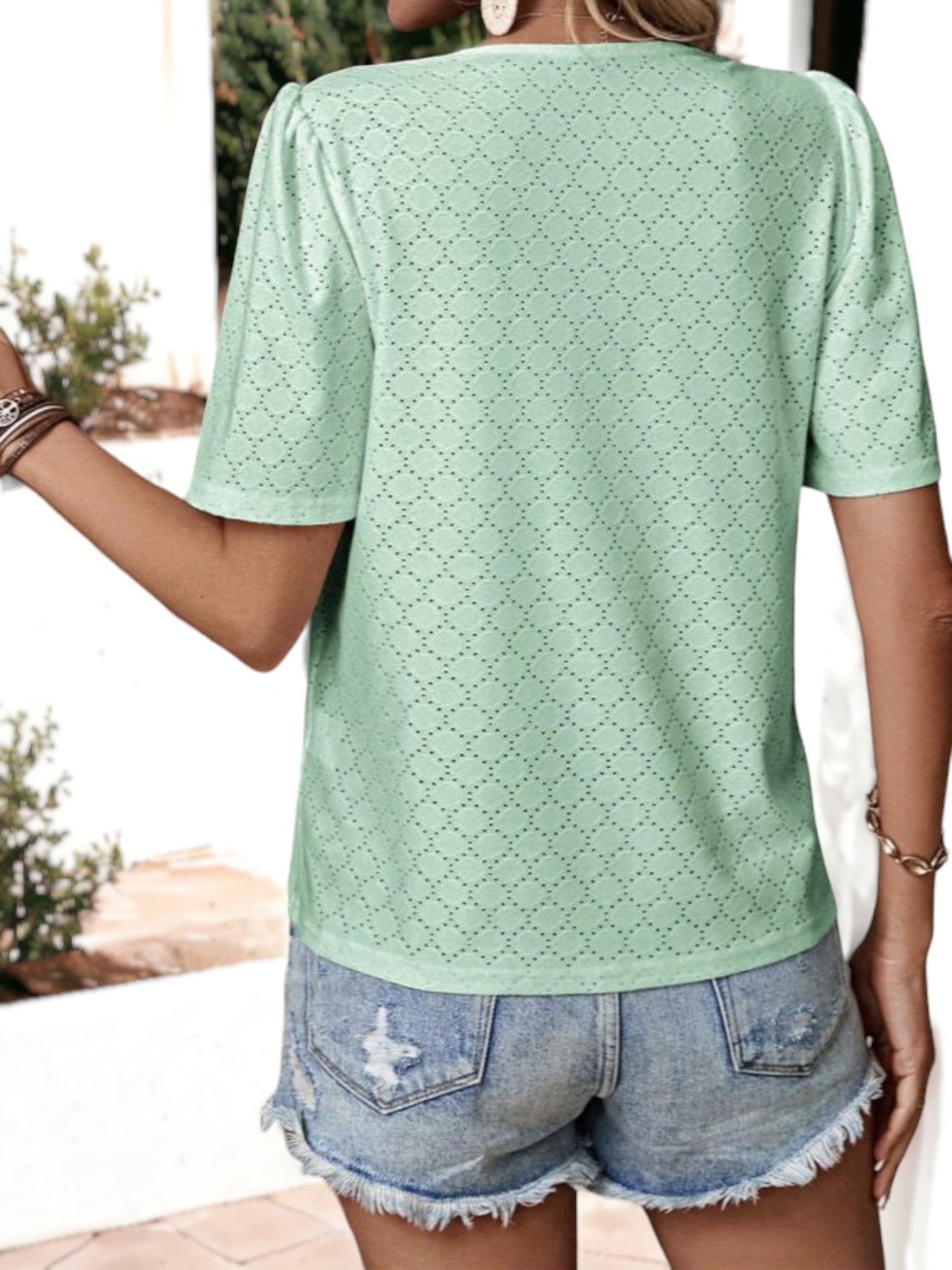 Blusa holgada transpirable con escote en V y ojales con botones