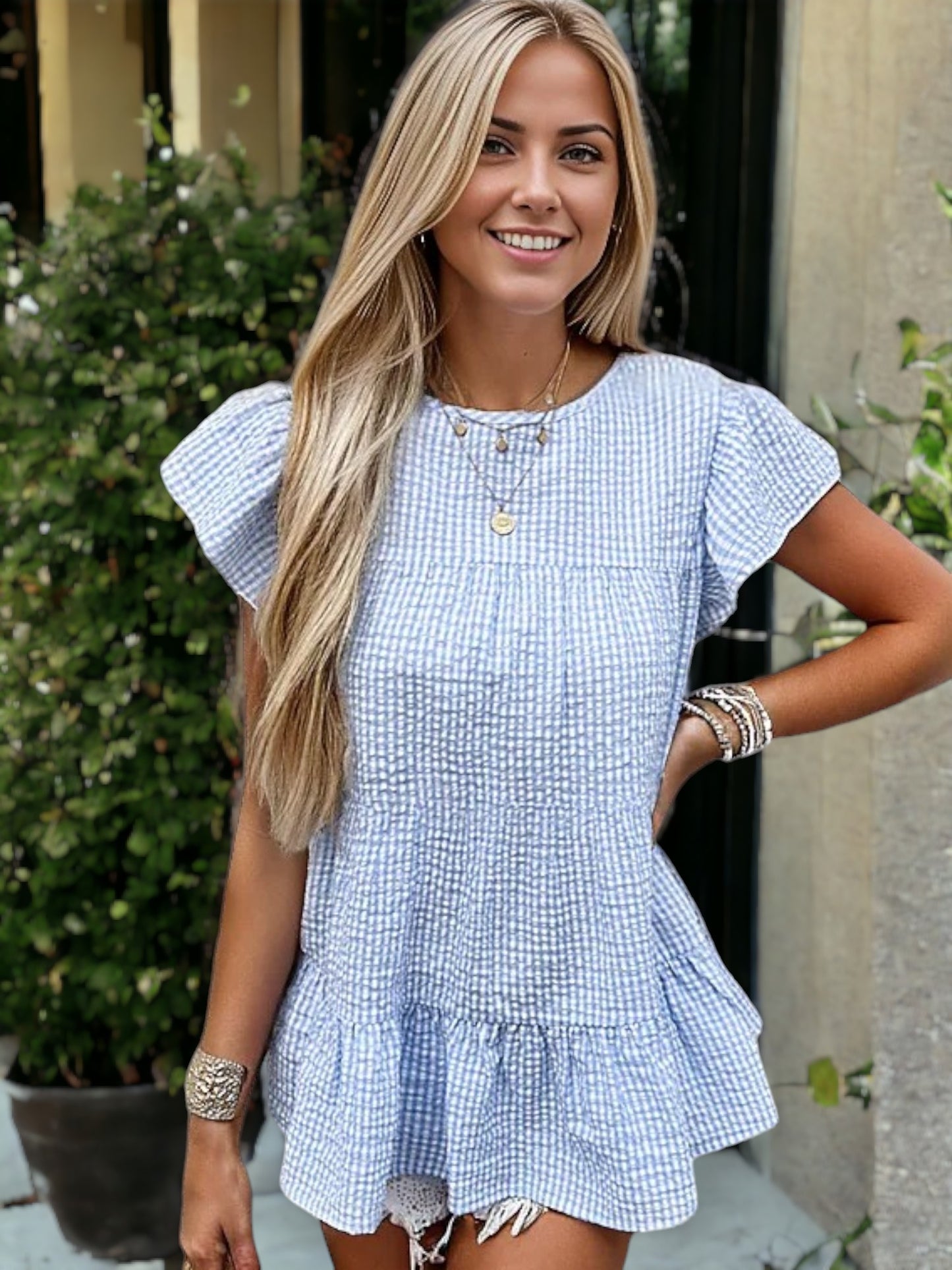 Blusa babydoll texturizada con mangas abullonadas y dobladillo con volantes