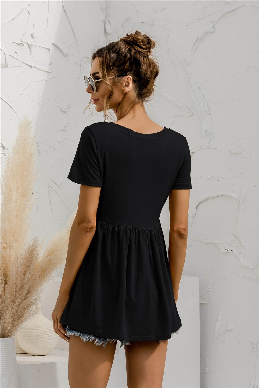 Blusa holgada con peplum liso