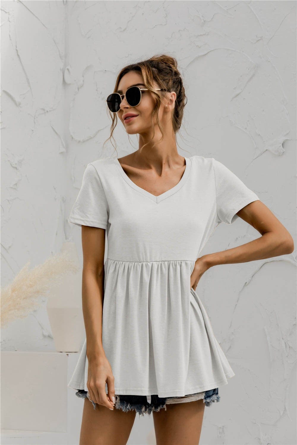 Blusa holgada con peplum liso