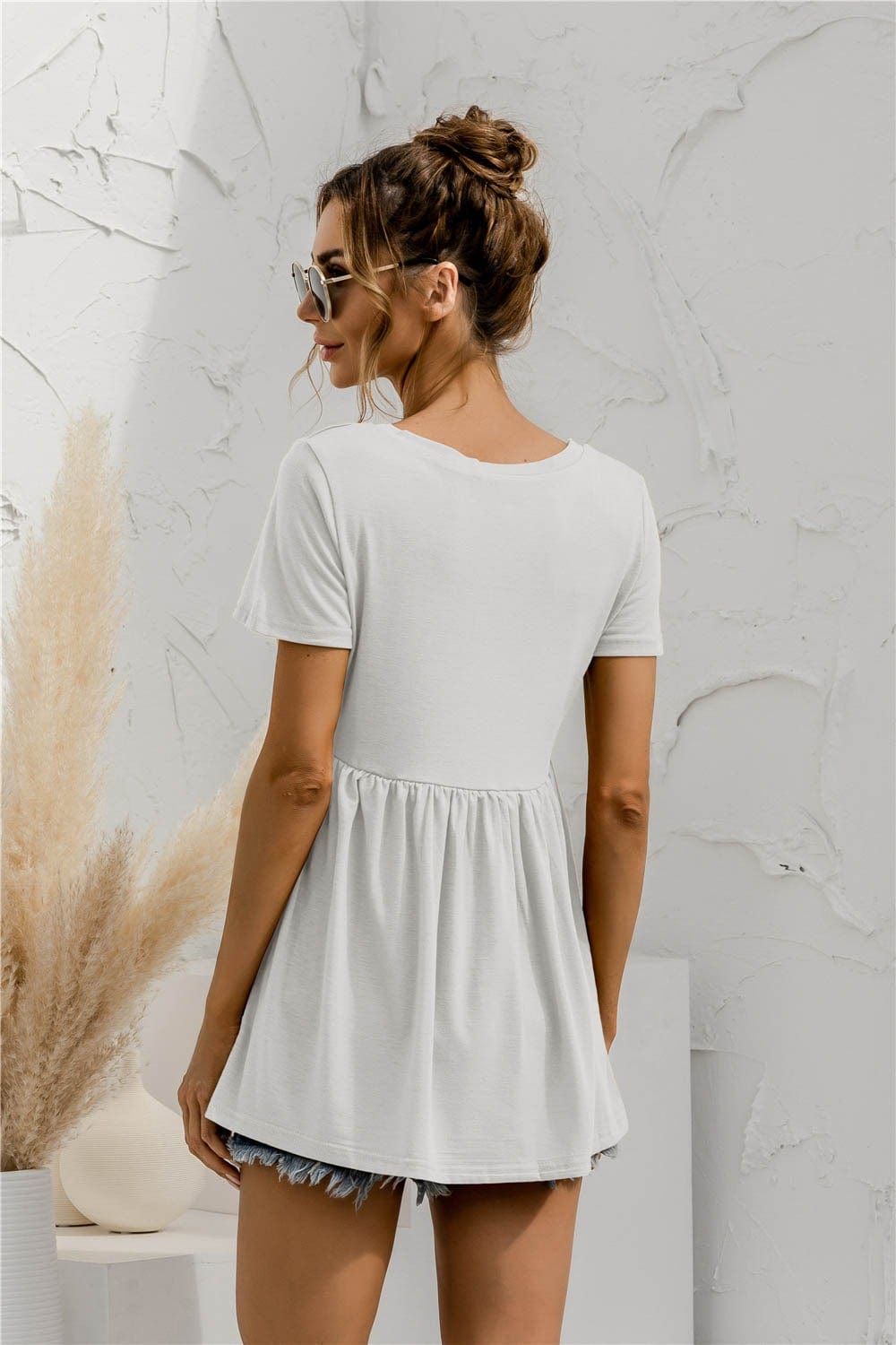 Blusa holgada con peplum liso