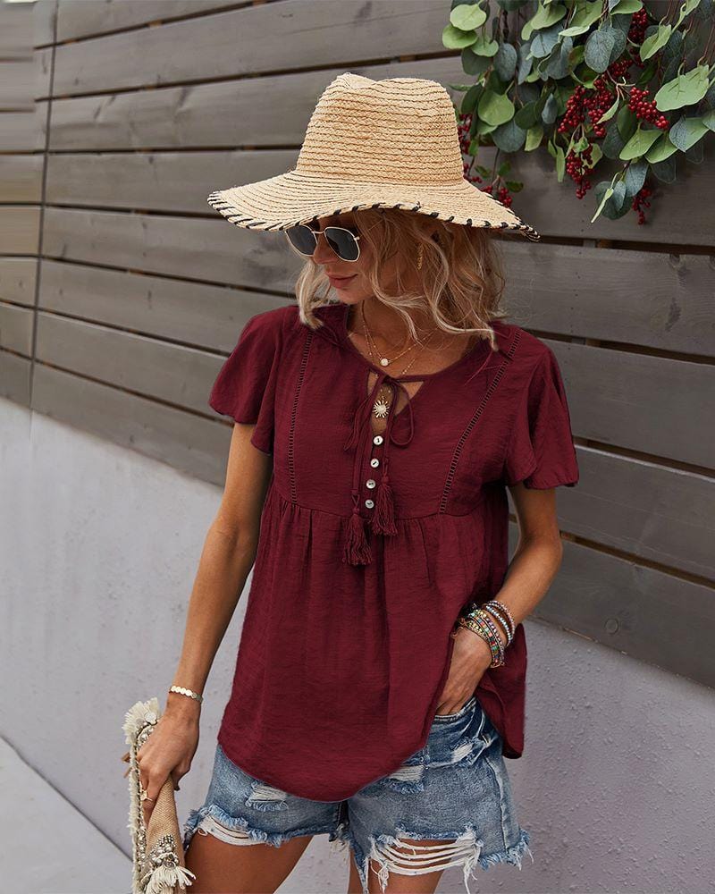 Blusa con mangas sueltas y cuello anudado