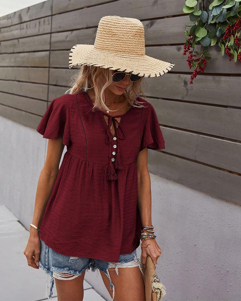 Blusa con mangas sueltas y cuello anudado