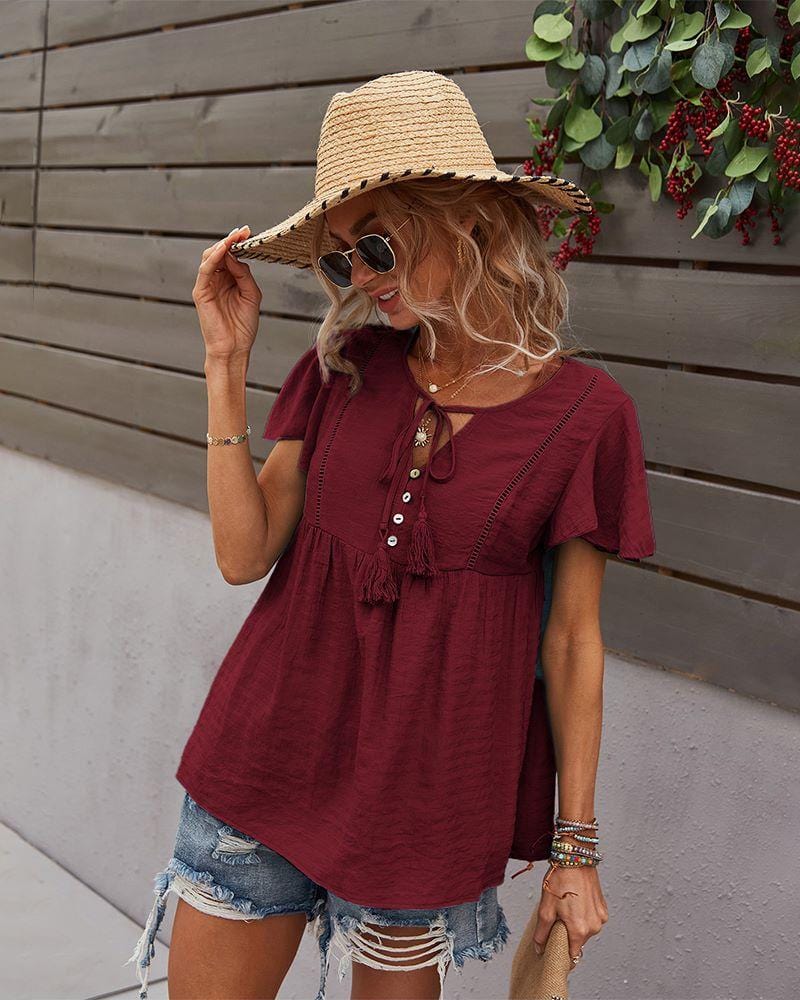 Blusa con mangas sueltas y cuello anudado