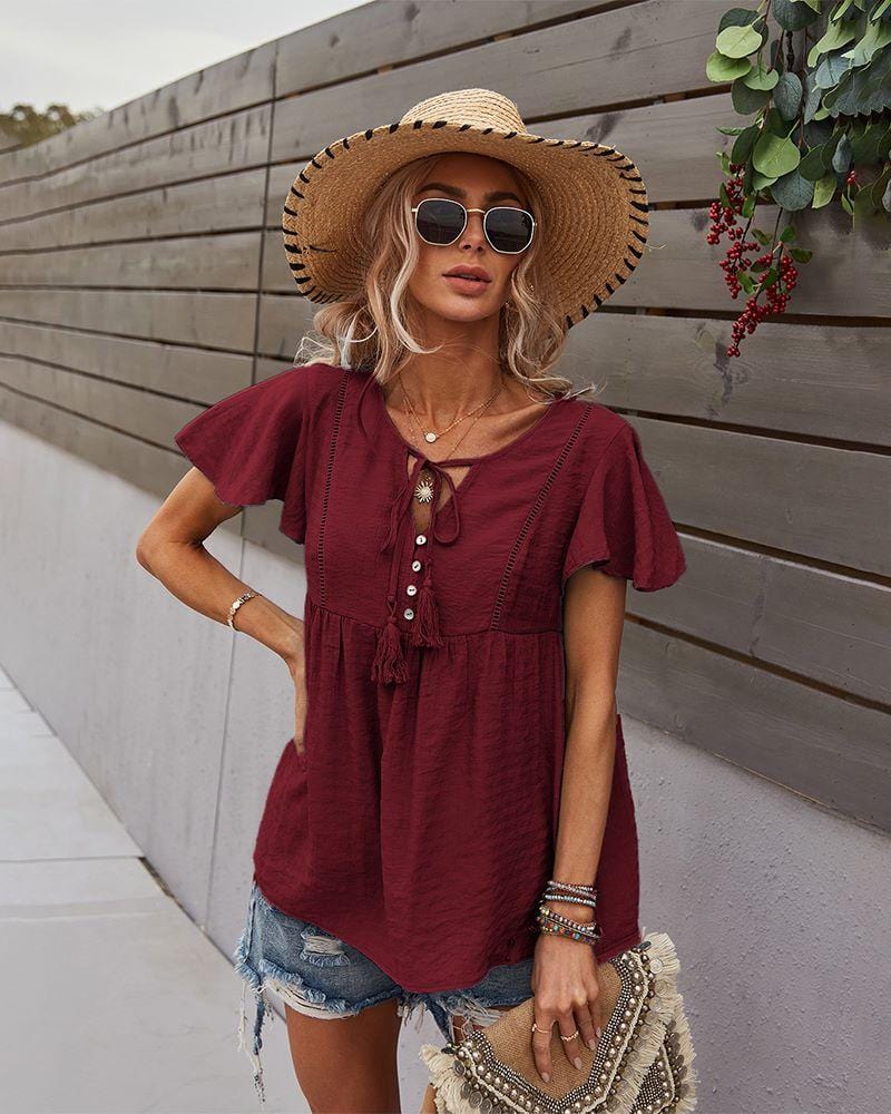 Blusa con mangas sueltas y cuello anudado