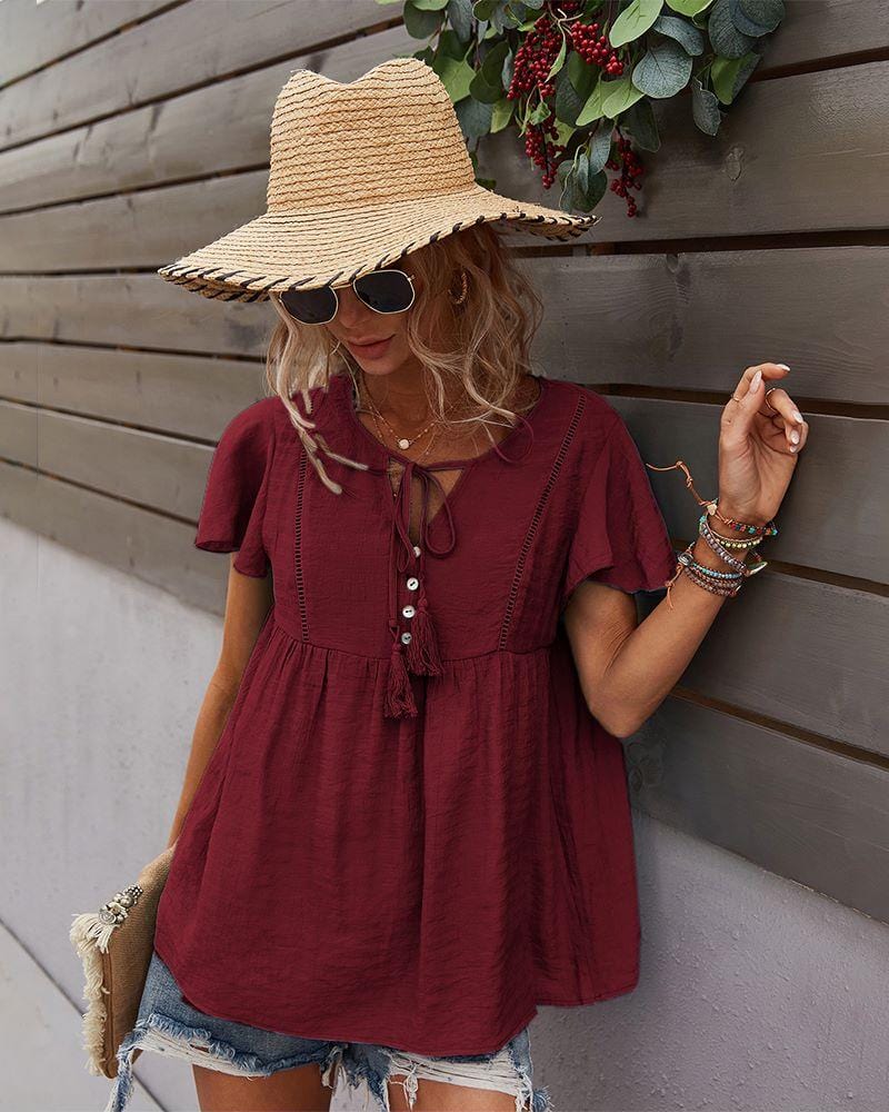 Blusa con mangas sueltas y cuello anudado
