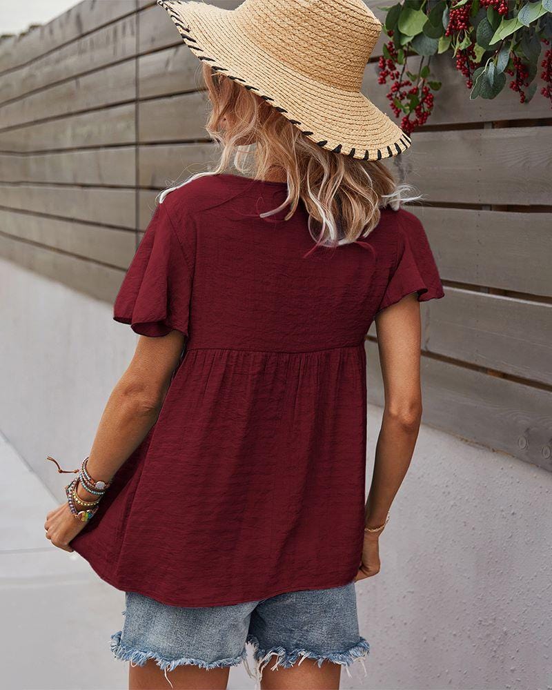 Blusa con mangas sueltas y cuello anudado