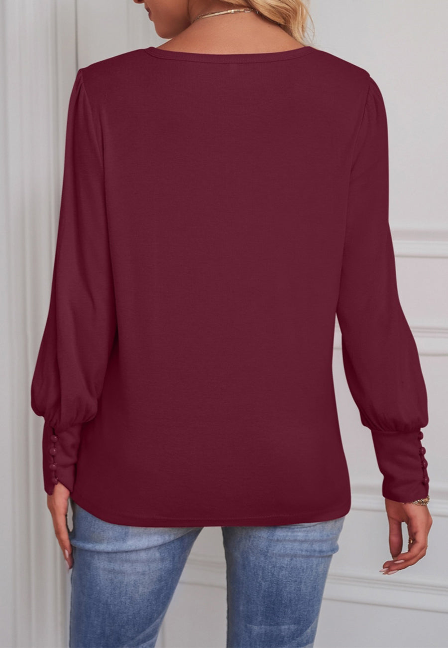 Blusa con puños abotonados en color liso