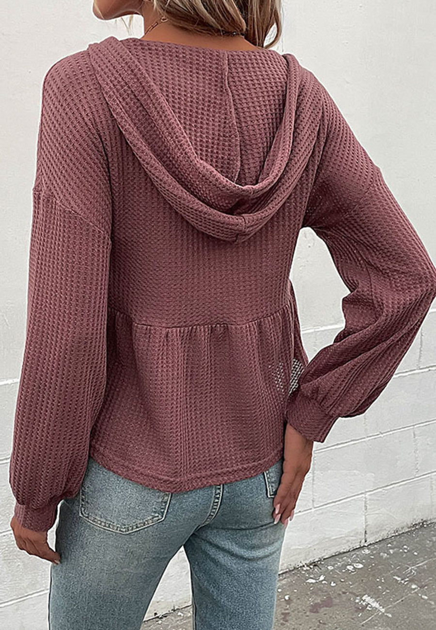 Suéter de punto peplum con capucha