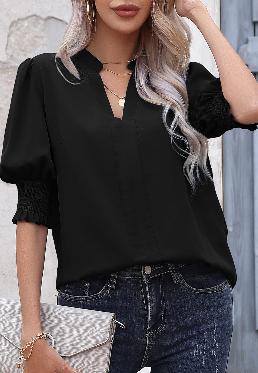 Blusa con mangas abullonadas y pliegues en la espalda