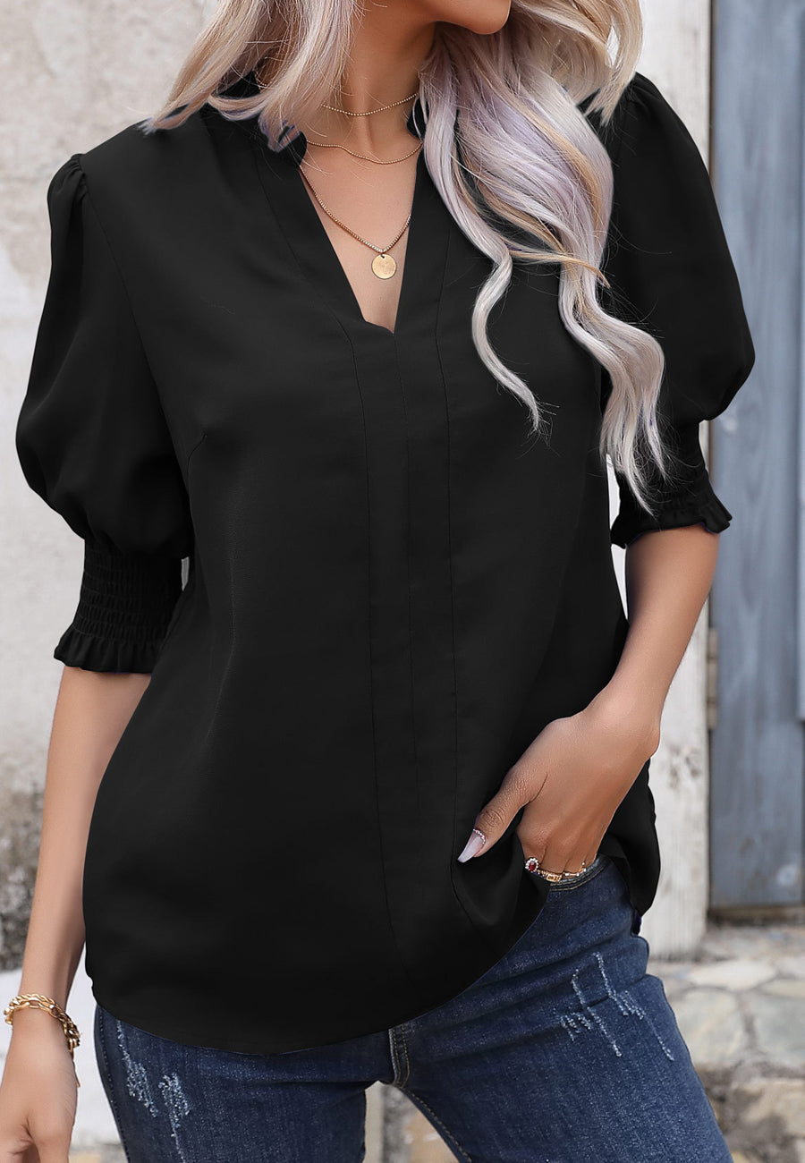 Blusa con mangas abullonadas y pliegues en la espalda