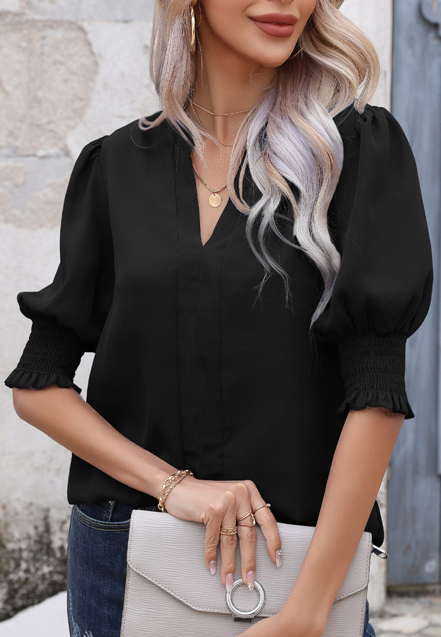 Blusa con mangas abullonadas y pliegues en la espalda