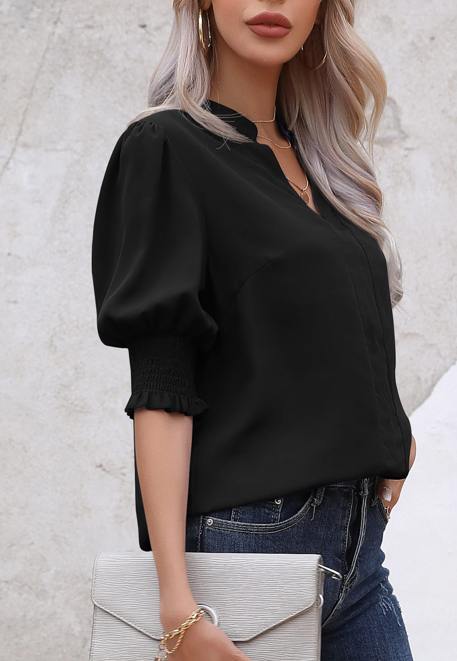 Blusa con mangas abullonadas y pliegues en la espalda