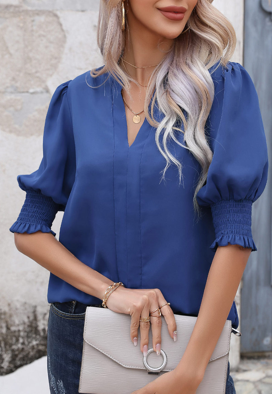 Blusa con mangas abullonadas y pliegues en la espalda
