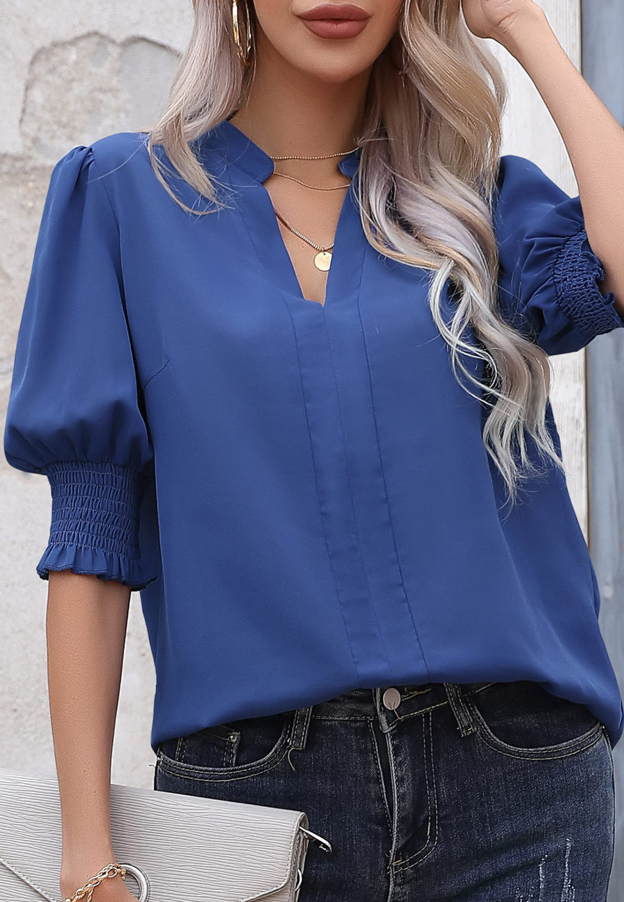 Blusa con mangas abullonadas y pliegues en la espalda