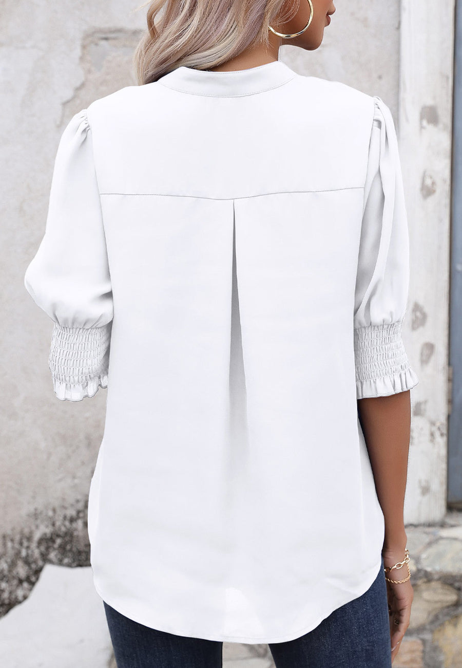 Blusa con mangas abullonadas y pliegues en la espalda