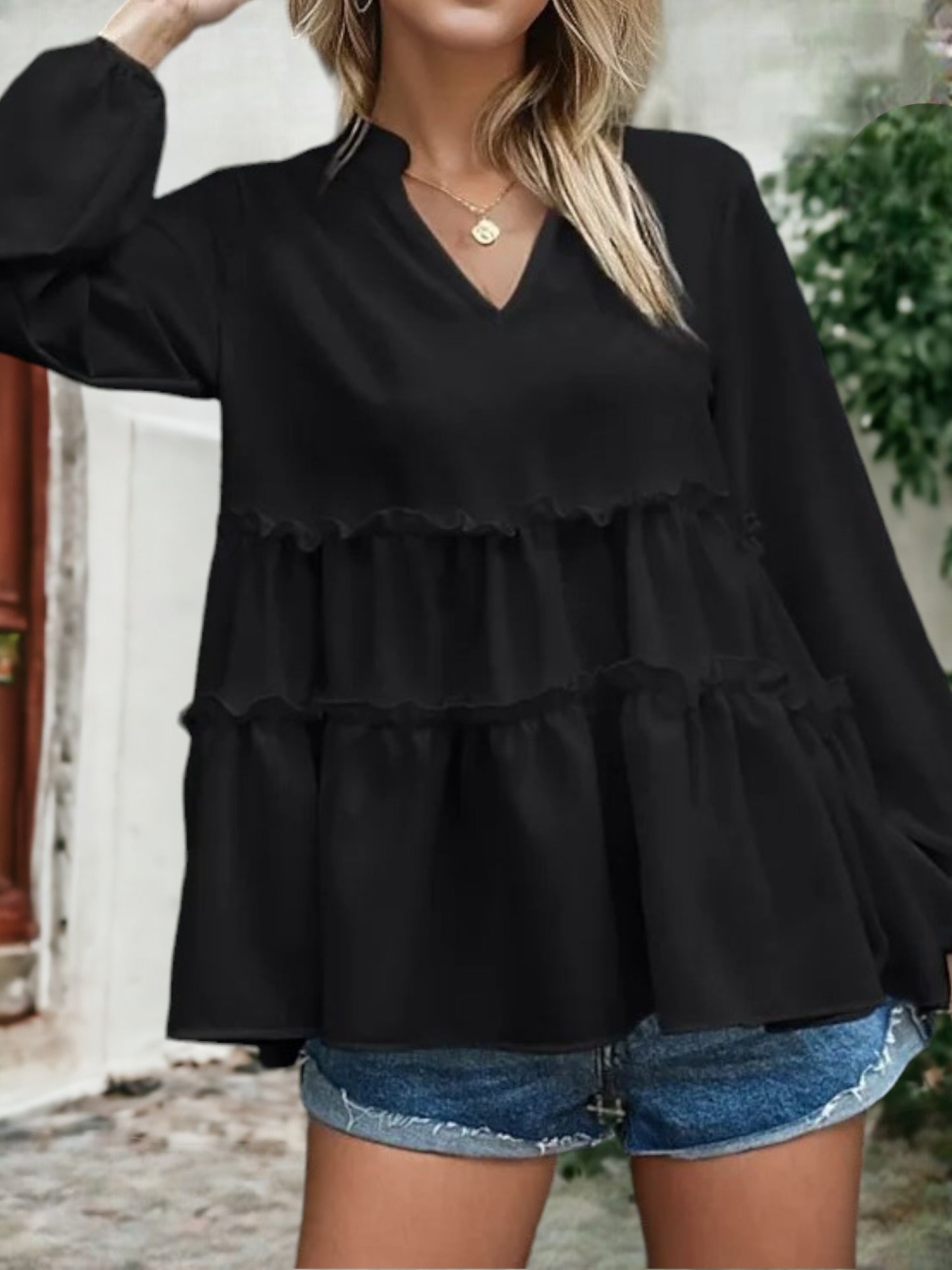 Blusa con cuello mandarín y dobladillo con volantes