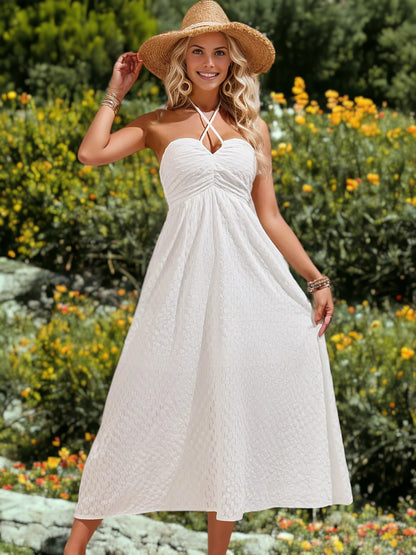 Vestido midi con cuello halter y tirantes finos cruzados de lunares suizos