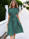 Vestido midi largo plisado con mangas estilo tulipán, cintura anudada y estampado floral