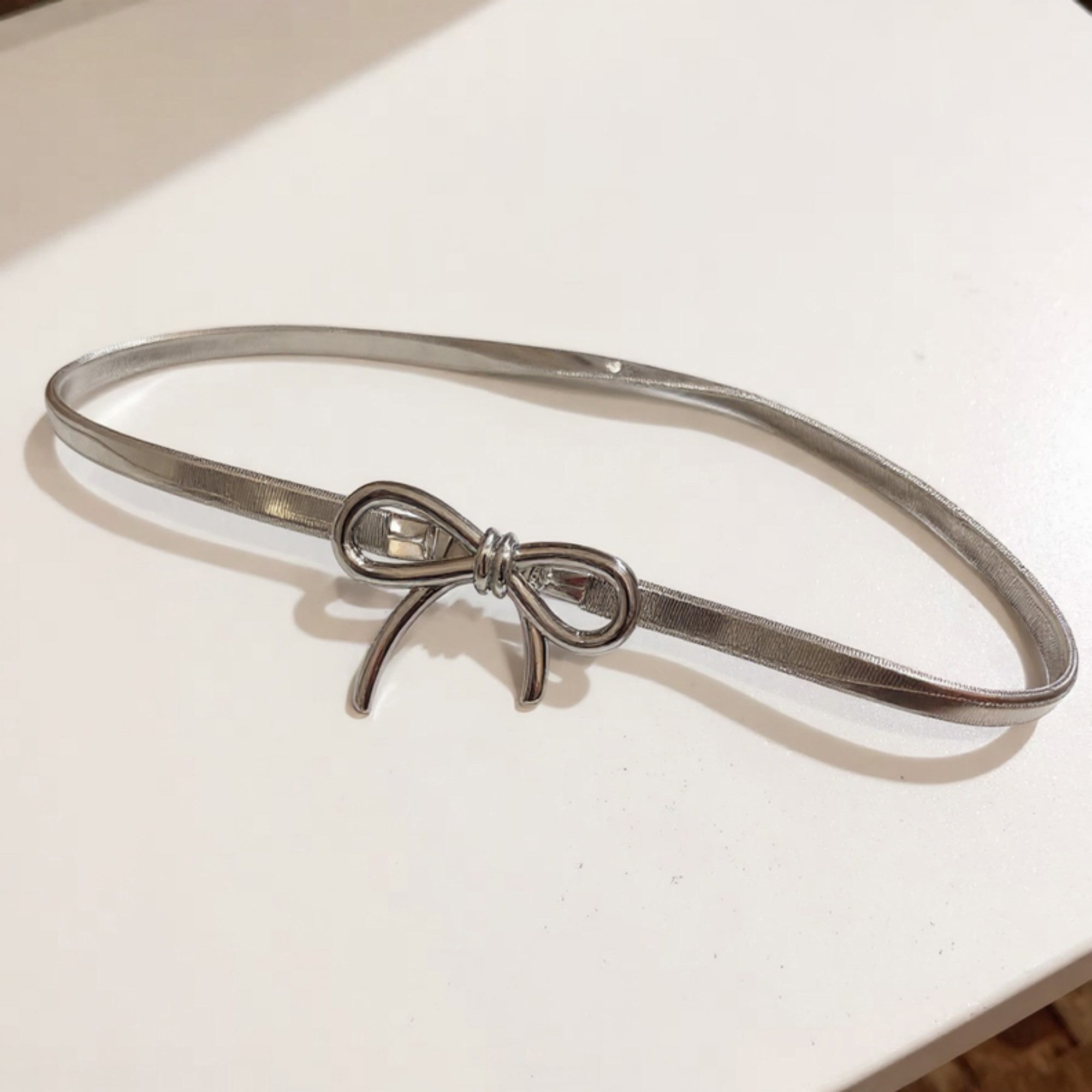 Anna-Kaci Women's Thin Metallic Belt with Polished Bow Accent and Adjustable Fit 27.5x0.4in