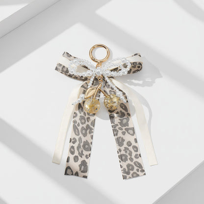 Anna-Kaci Leopard Print Ribbon Keychain with Pearl Bow and Cherry Charms
