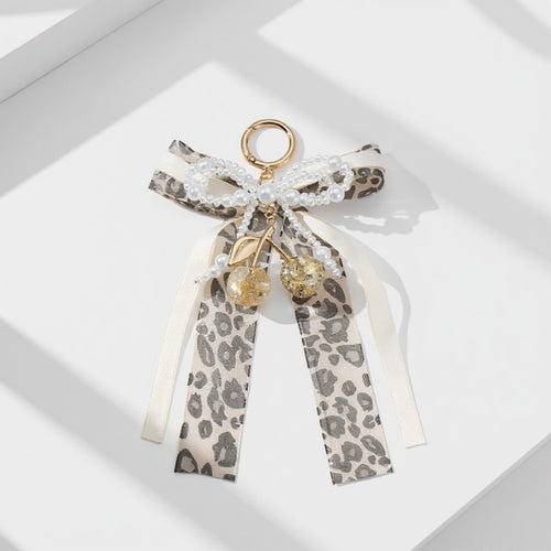 Anna-Kaci Leopard Print Ribbon Keychain with Pearl Bow and Cherry Charms