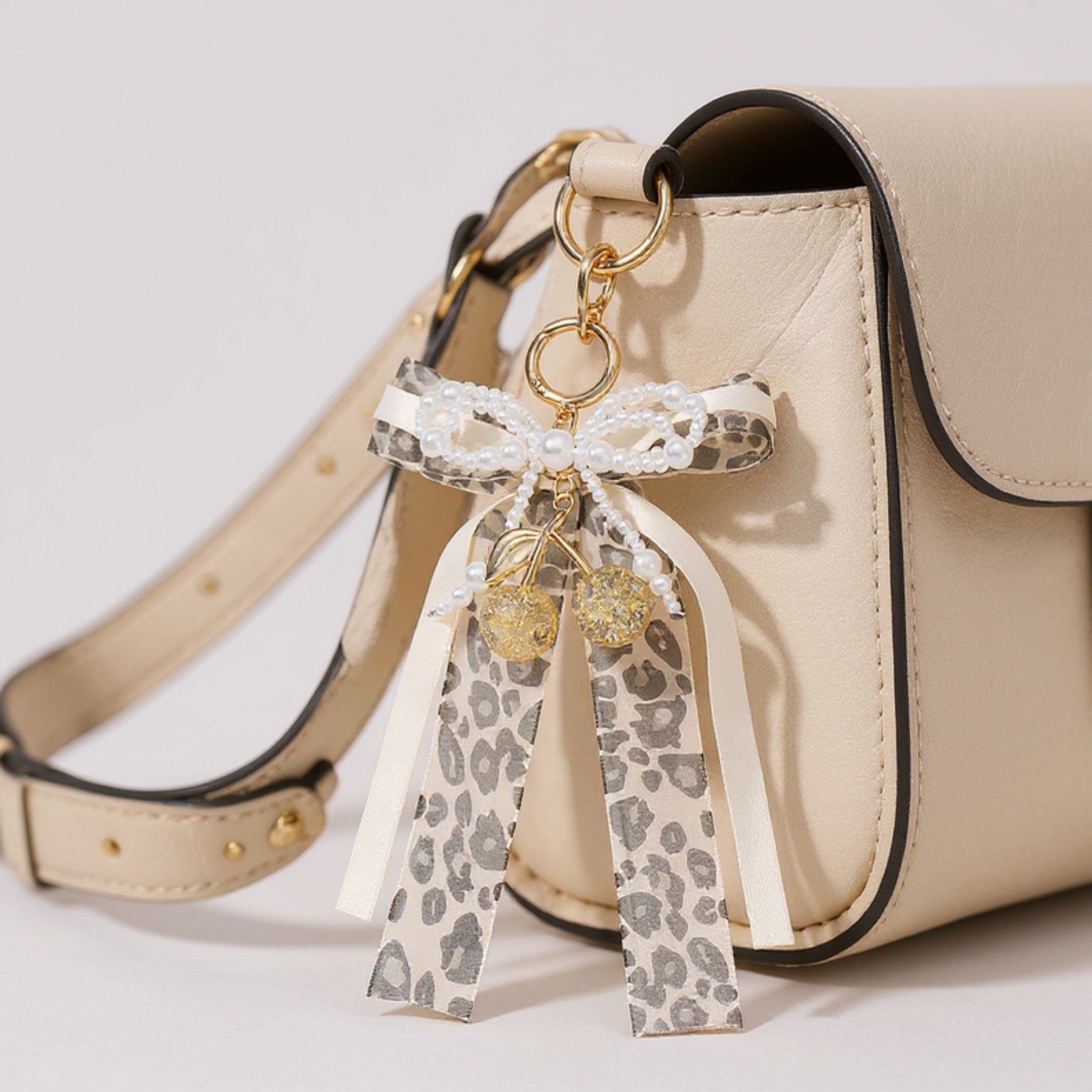 Anna-Kaci Leopard Print Ribbon Keychain with Pearl Bow and Cherry Charms