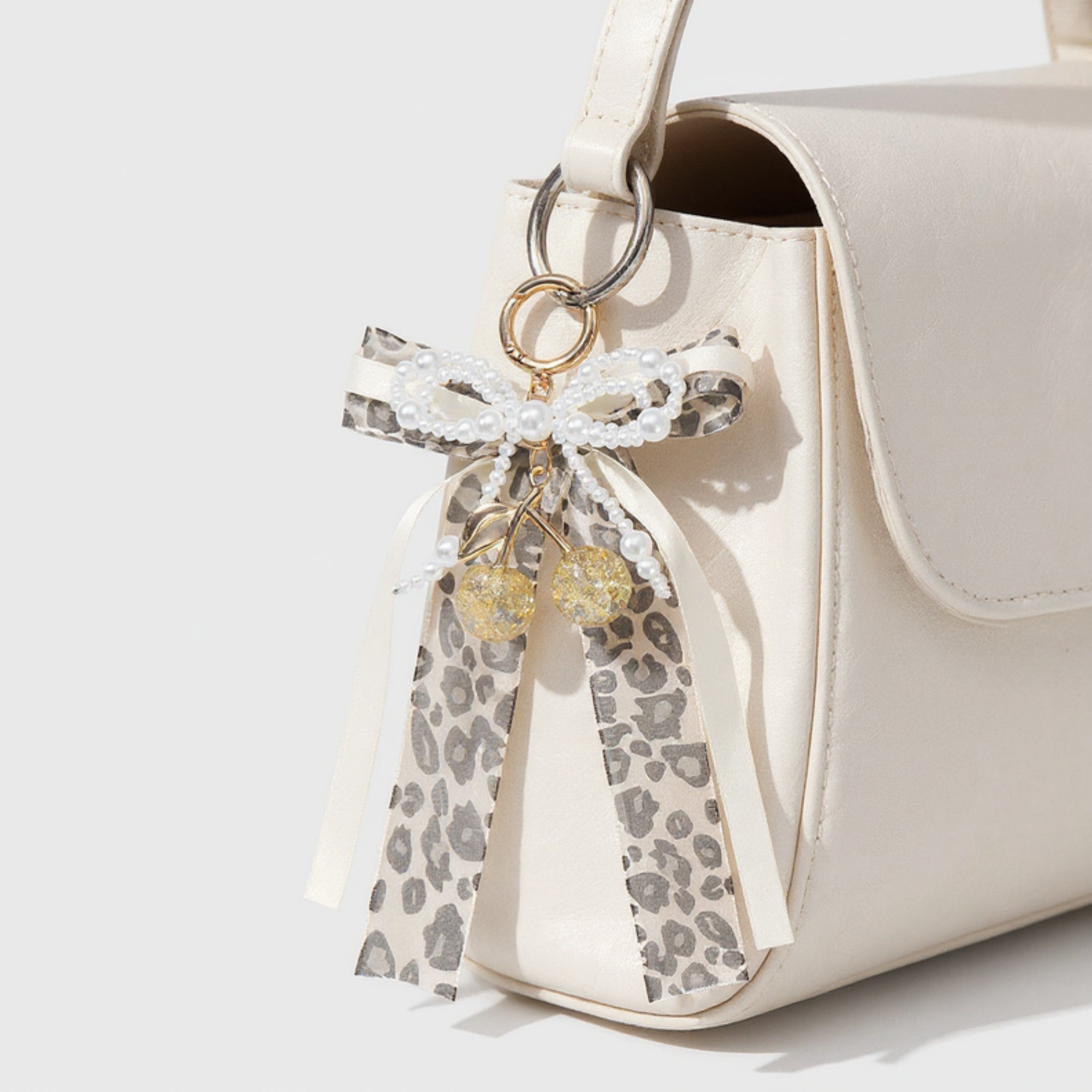Anna-Kaci Leopard Print Ribbon Keychain with Pearl Bow and Cherry Charms