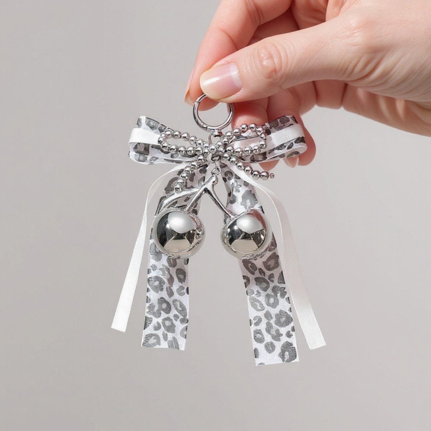 Anna-Kaci Leopard Print Ribbon Keychain with Pearl Bow and Cherry Charms