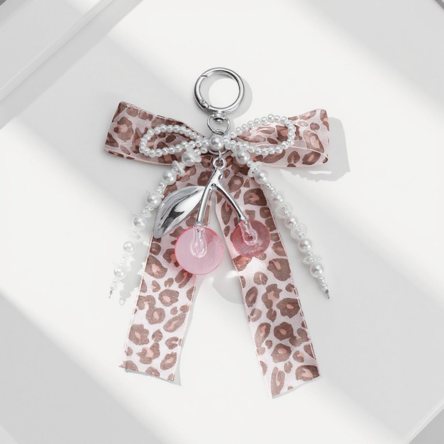 Anna-Kaci Leopard Print Ribbon Keychain with Pearl Bow and Cherry Charms