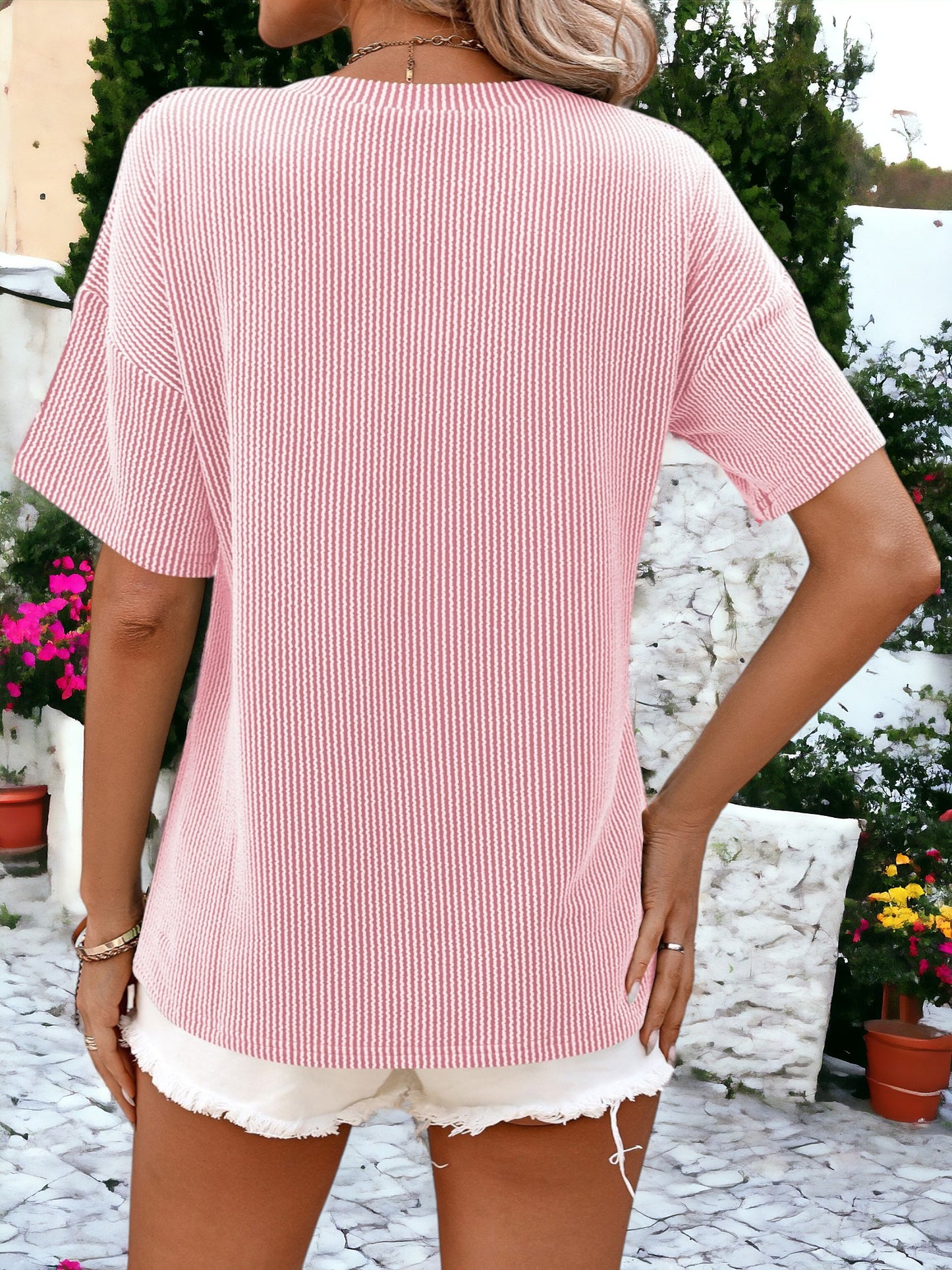 Camiseta holgada con cuello redondo, textura de rayas y bolsillos laterales detallados