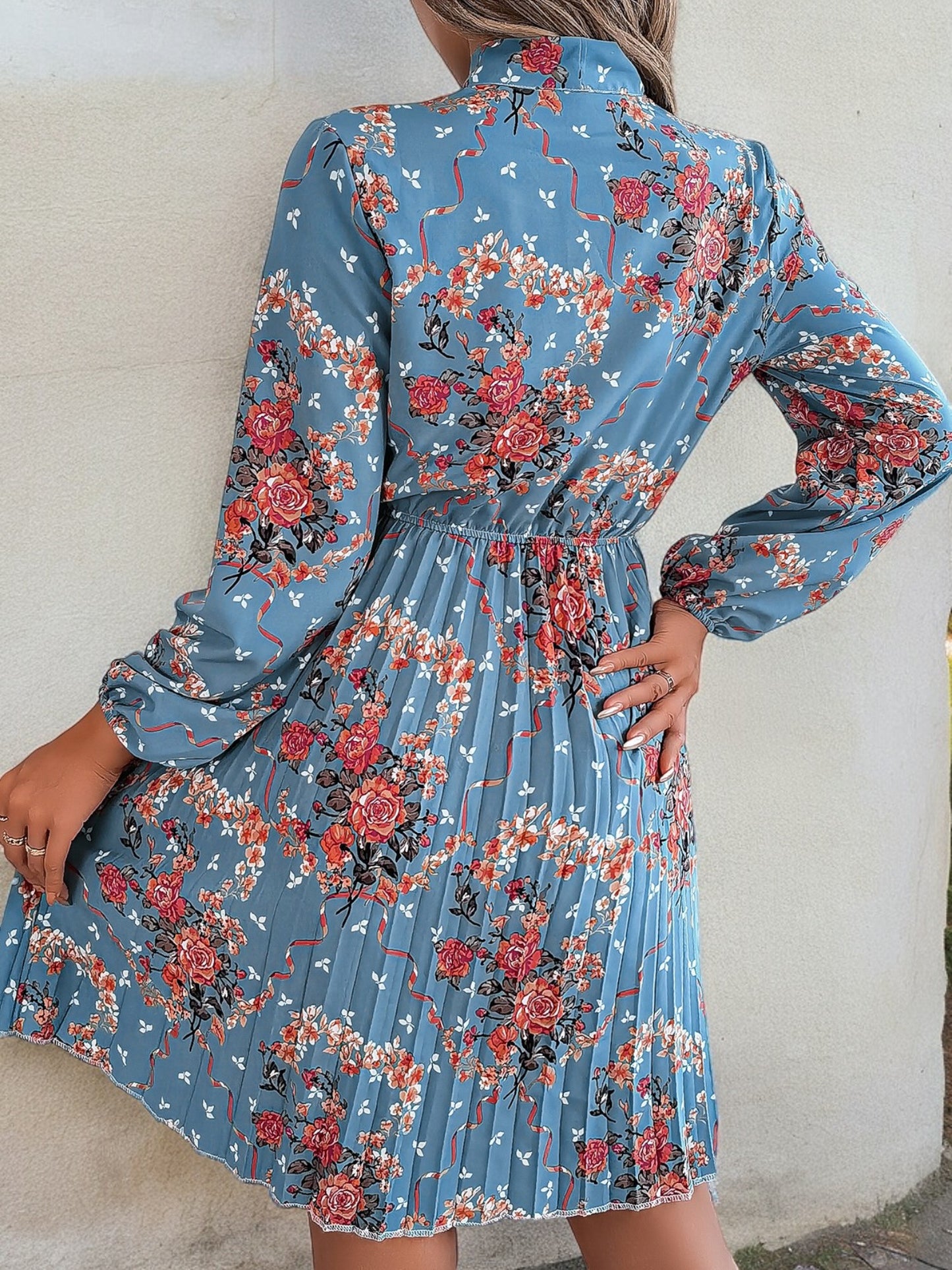 Vestido con estampado floral de manga larga, cuello con lazo y falda plisada