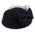 Red women's hat with bow, birdcage veil and classic charm