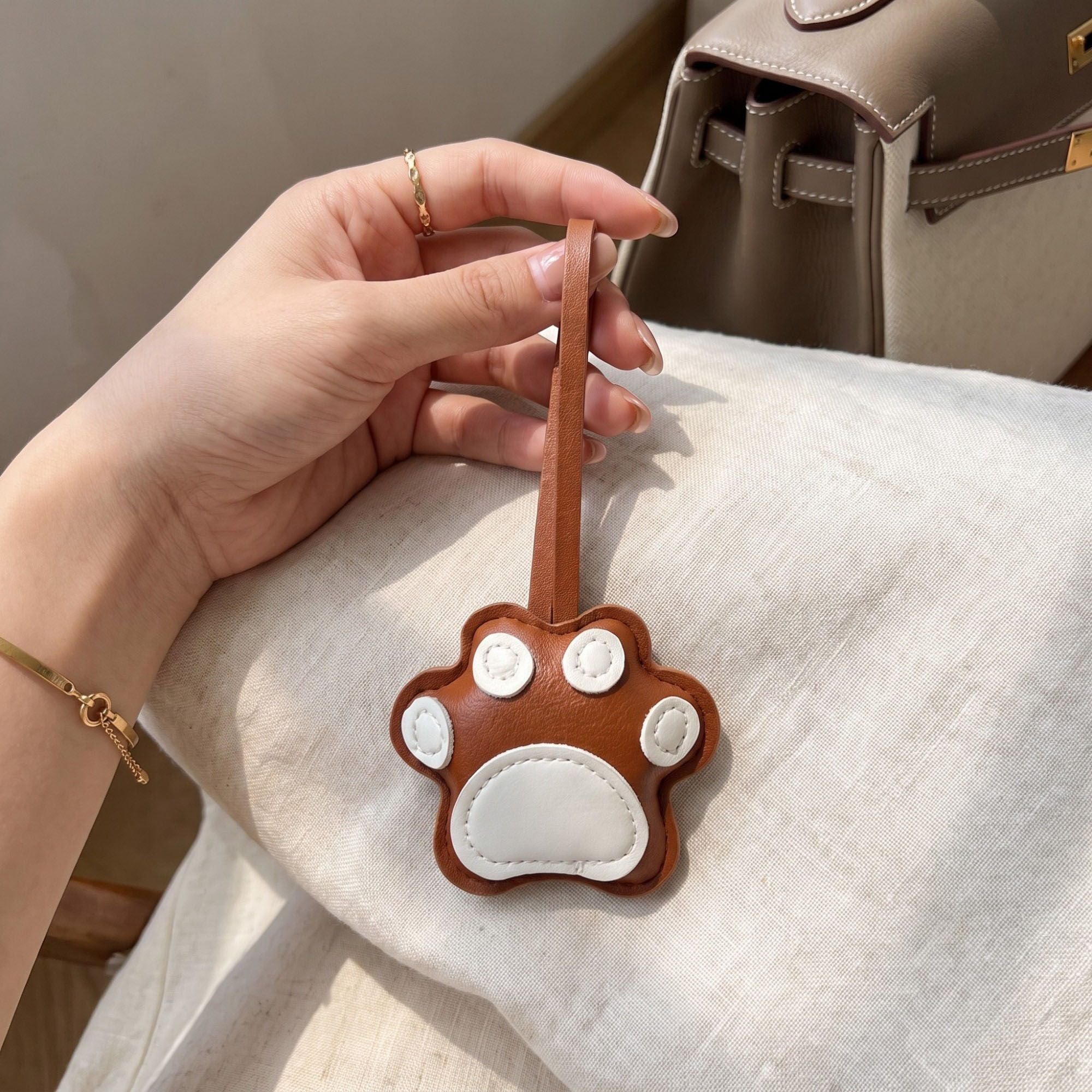 2-Piece Womens Faux Leather Paw Print Bag Charm with Long Hanging Strap and Padded Detail