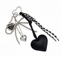 Pink charm accessory with faux leather, bow and beaded