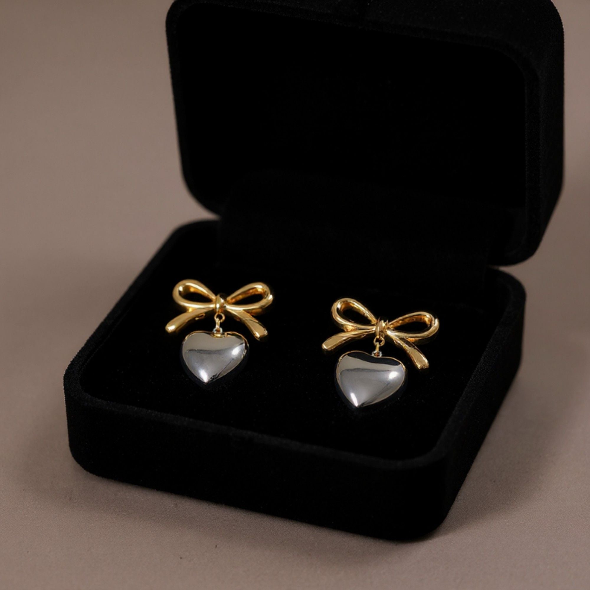 Women's Bow Stud Earrings with Metallic Heart Dangle Charm and Polished Modern Cute Design