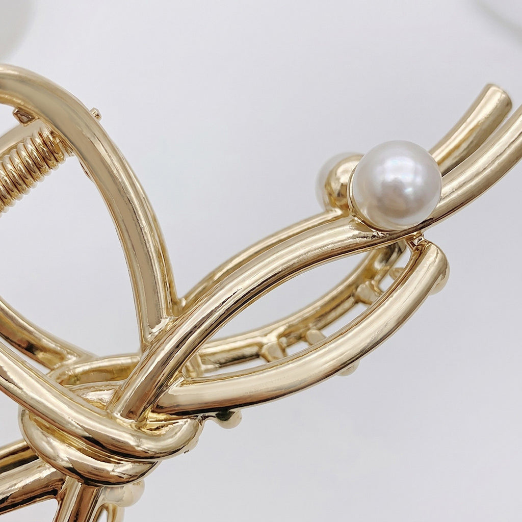 Bow Shaped Hair Clip with Faux Pearl Accent and Open Frame Design 4.5x1in
