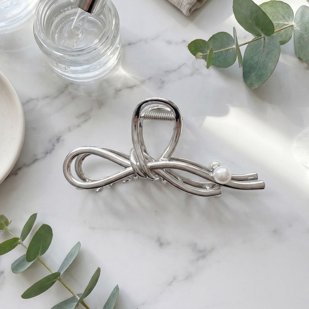 Bow Shaped Hair Clip with Faux Pearl Accent and Open Frame Design 4.5x1in