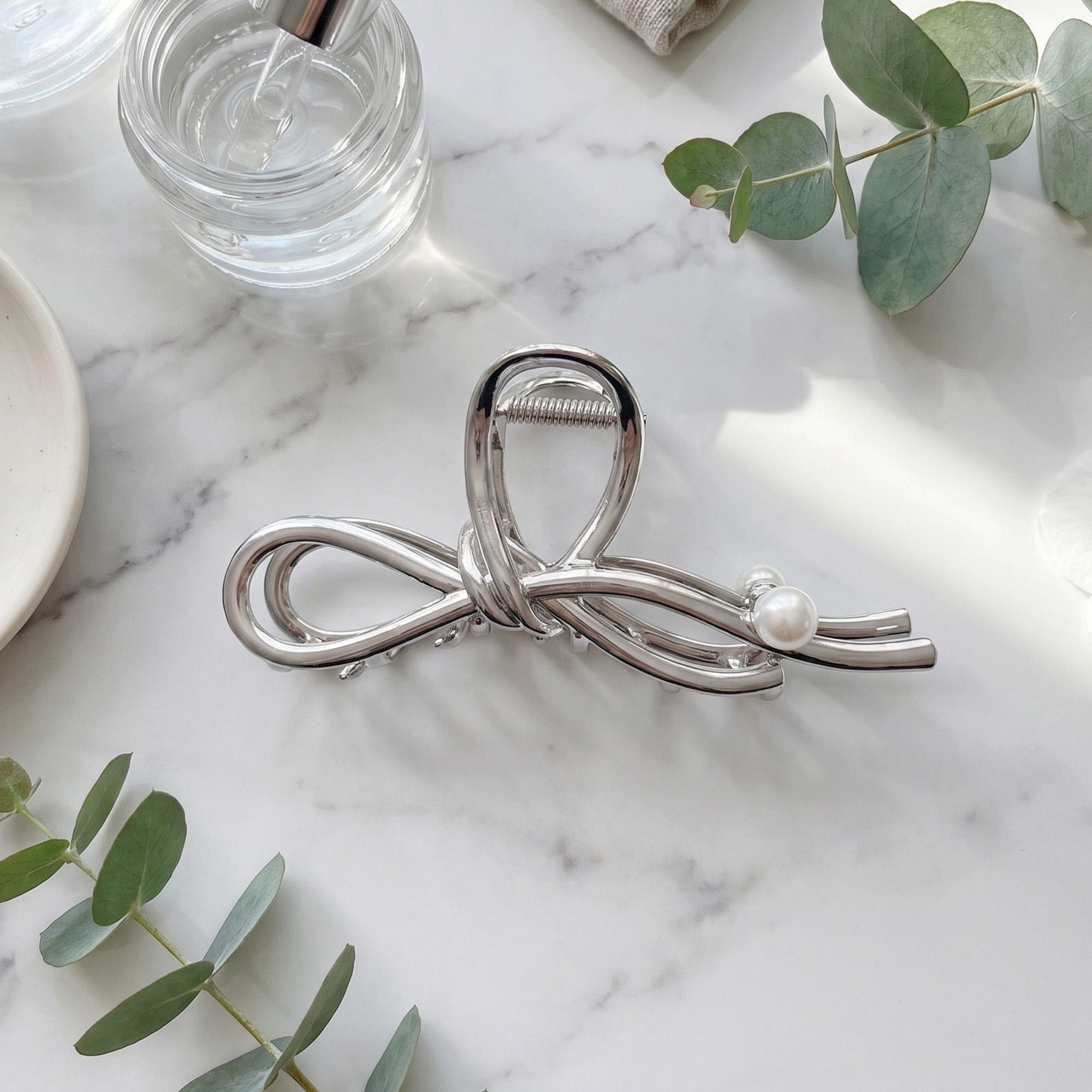 Bow Shaped Hair Clip with Faux Pearl Accent and Open Frame Design 4.5x1in