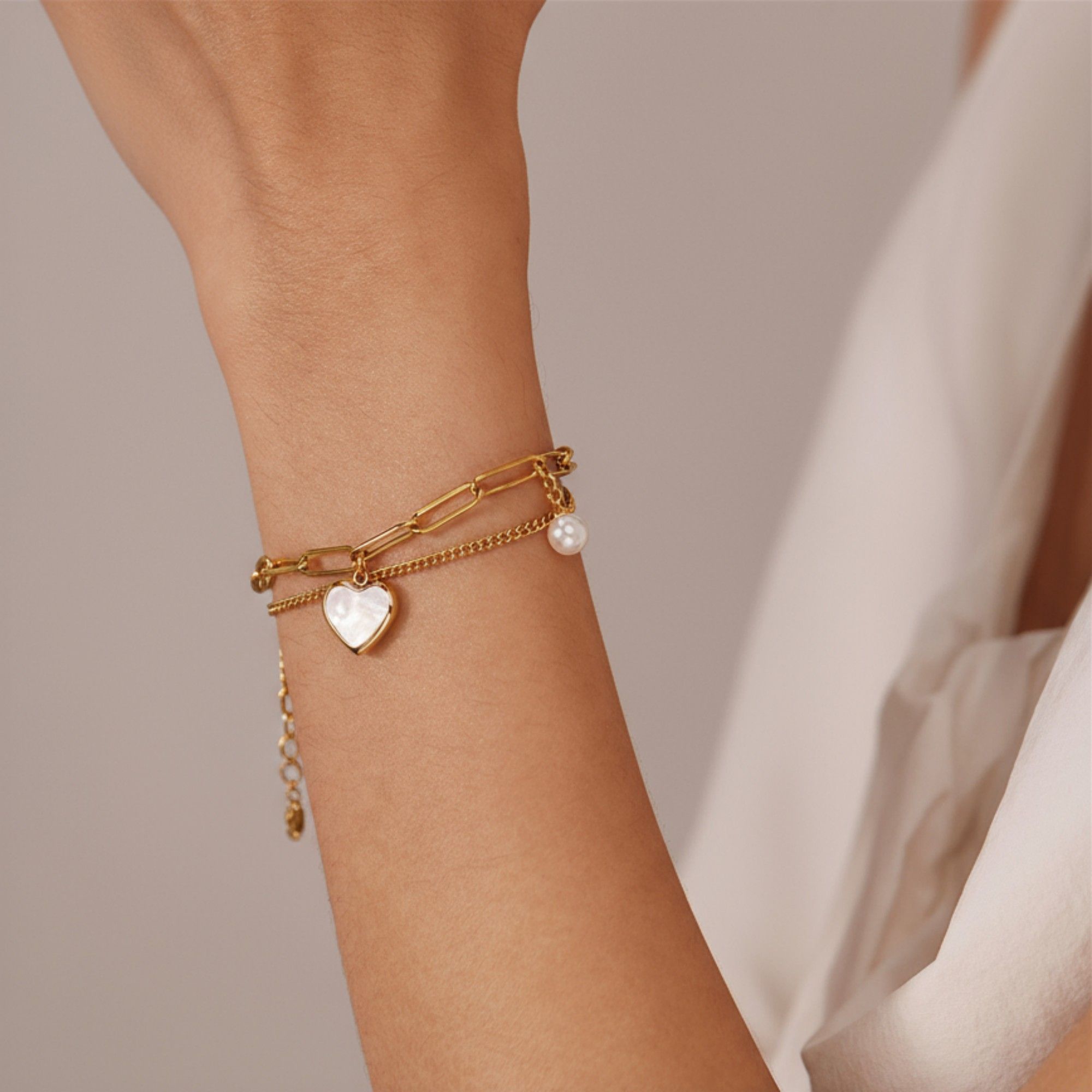 Double Layer Chain Bracelet with Heart Charm Pendant and Smooth Bead Drop Detail for a Delicate Feminine Layered Look