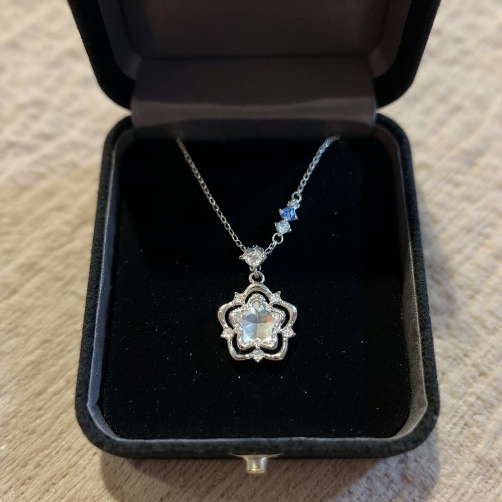 Women's Star Flower Pendant Necklace with Crystal Center Stone and Accent Gem Detailing
