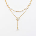 Layered Chain Necklace with Delicate Pearl Accents and Open Petal Floral Pendant Featuring Droplet Charm Detail