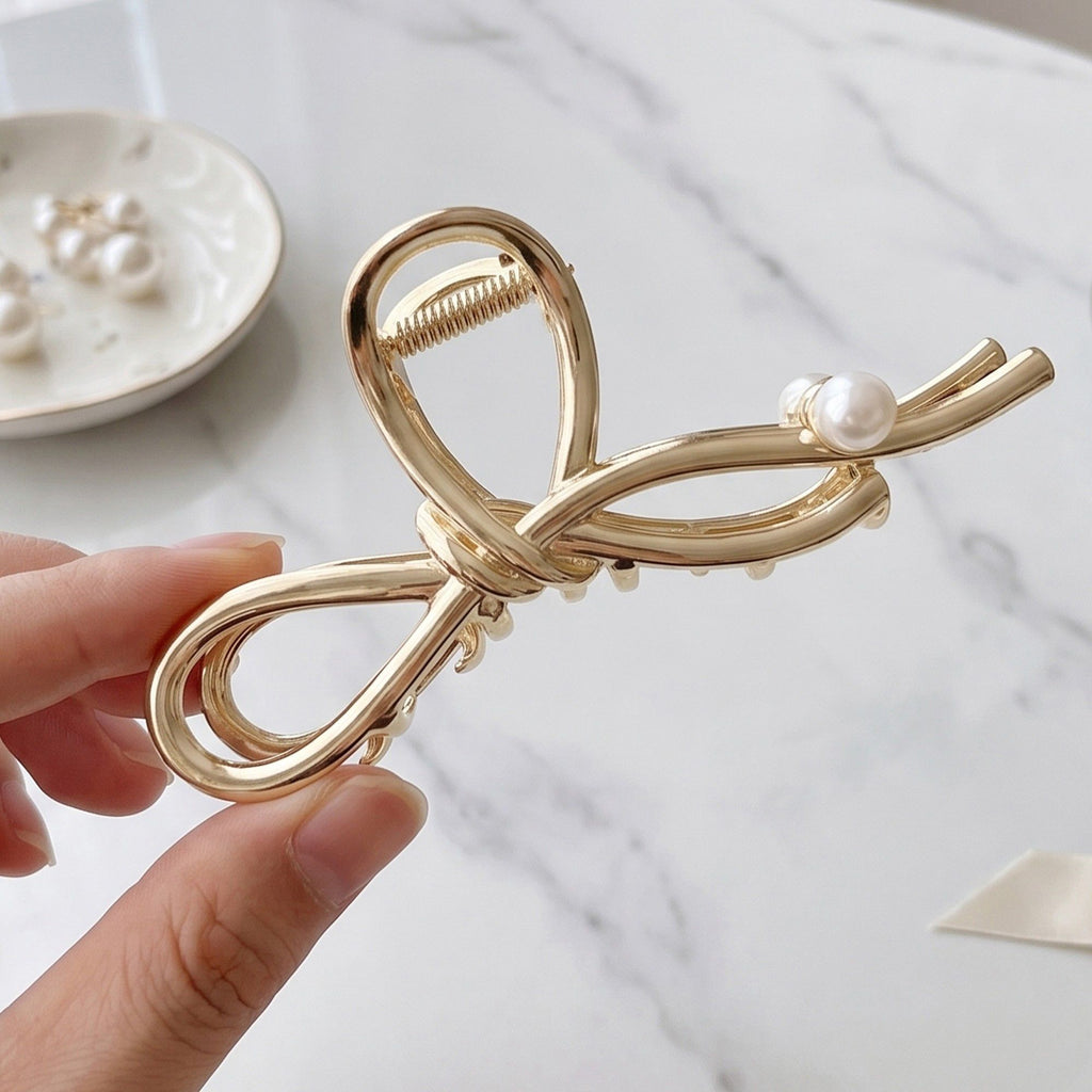 Bow Shaped Hair Clip with Faux Pearl Accent and Open Frame Design 4.5x1in