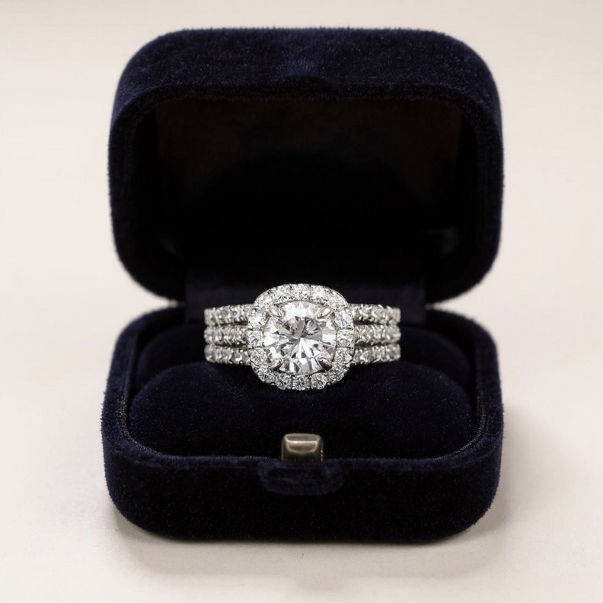 Women's Cushion Halo Engagement Ring with Round Cut Center Stone and Triple Band Design