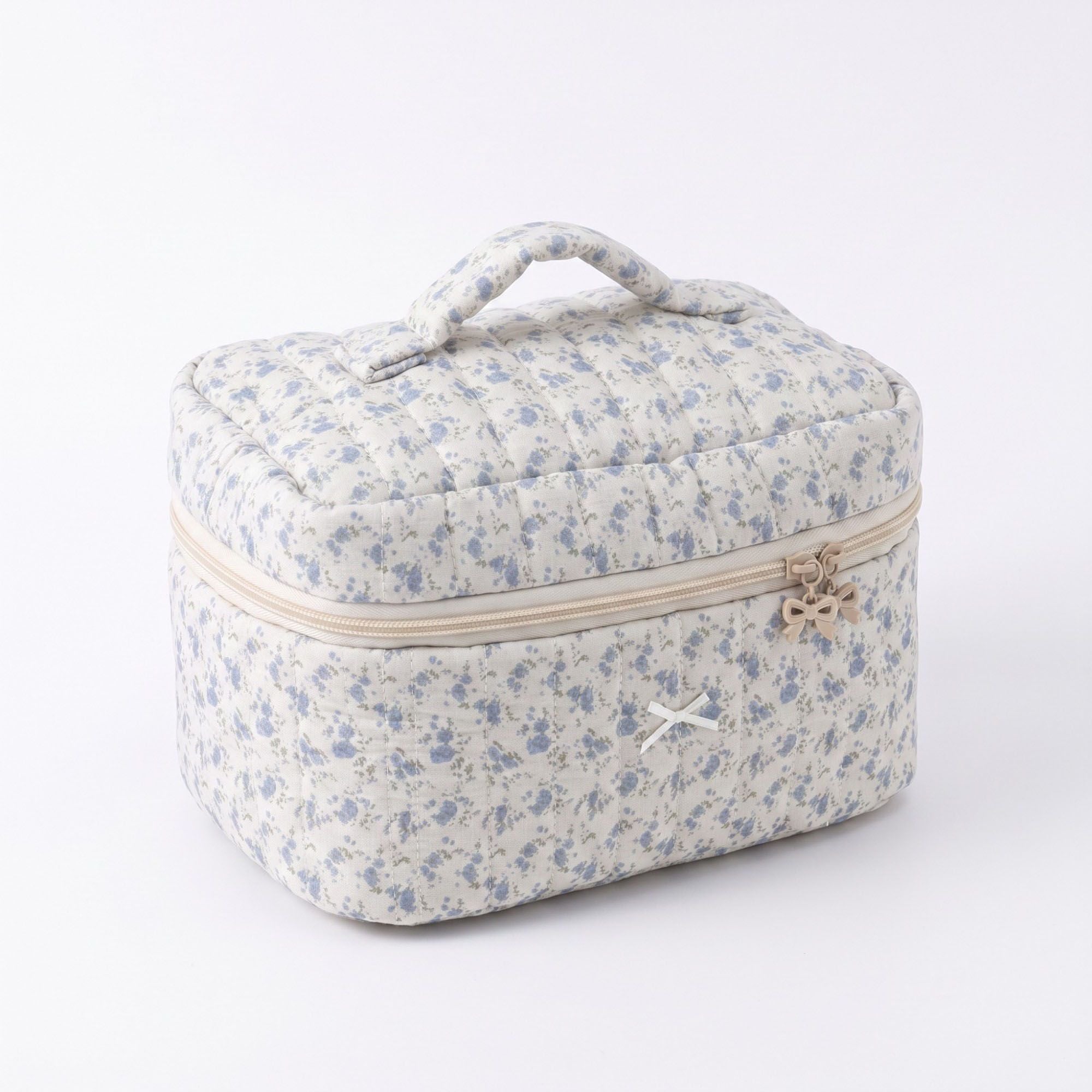Bolsa de maquillaje acolchada con estampado floral, asa superior y cierre de cremallera