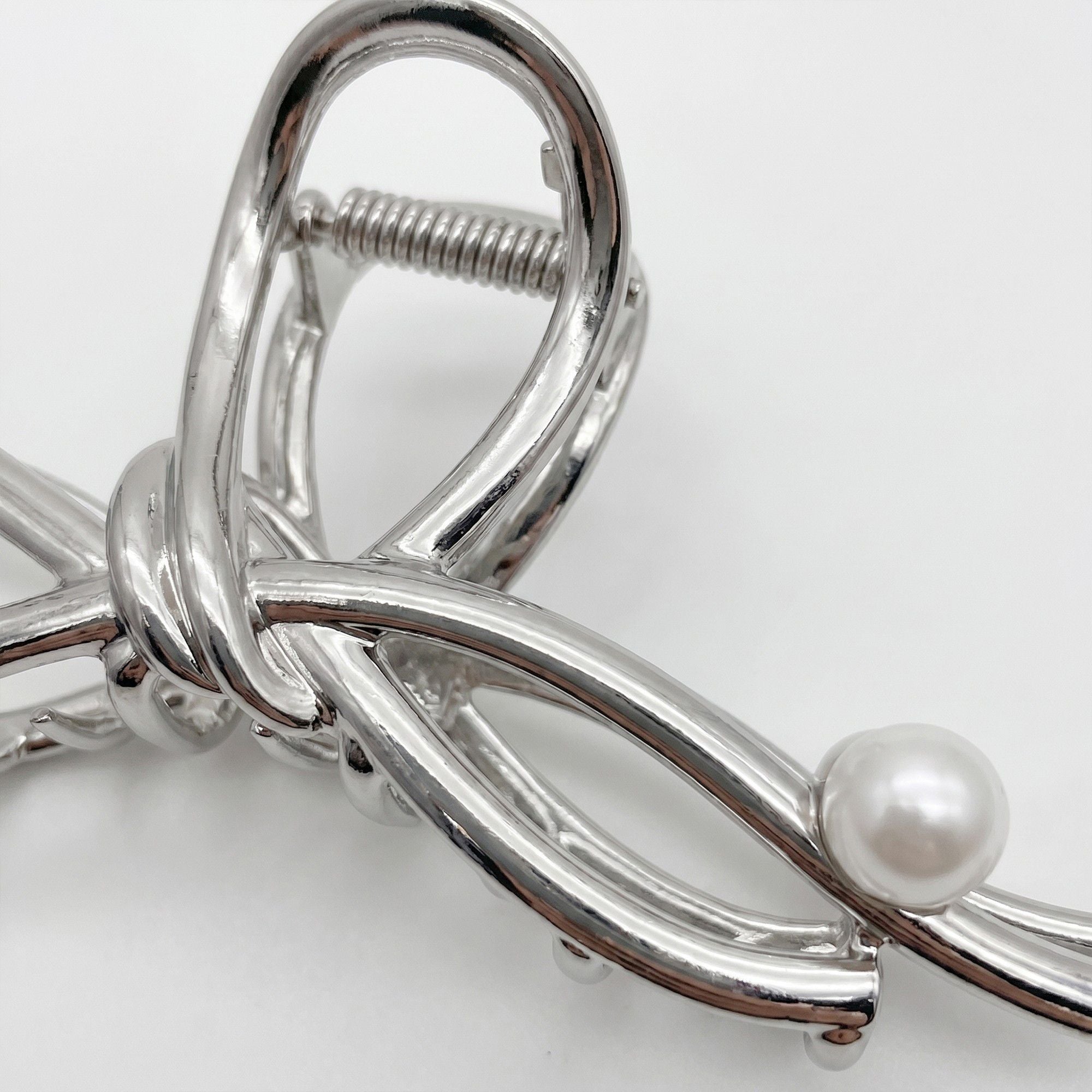 Bow Shaped Hair Clip with Faux Pearl Accent and Open Frame Design 4.5x1in