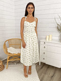 Vestido midi con abertura en la pierna, tirantes y lazo con flores 