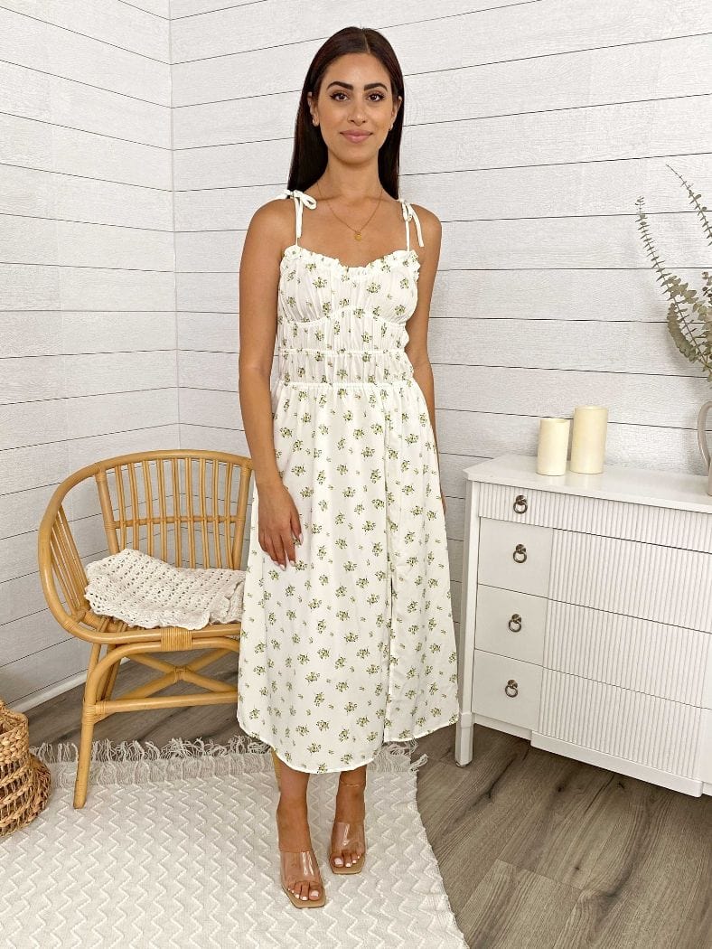 Vestido midi con abertura en la pierna, tirantes y lazo con flores 